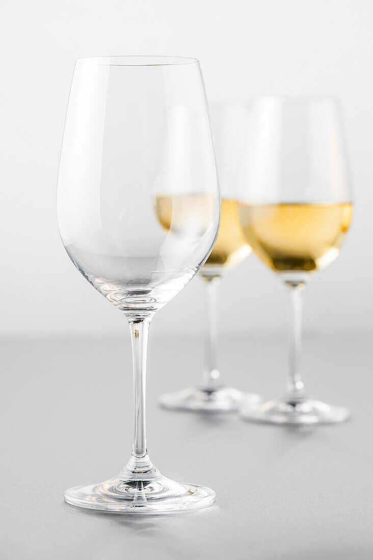 Two glasses of white wine and an empty glass, Hamburg, Northern Germany, Germany
