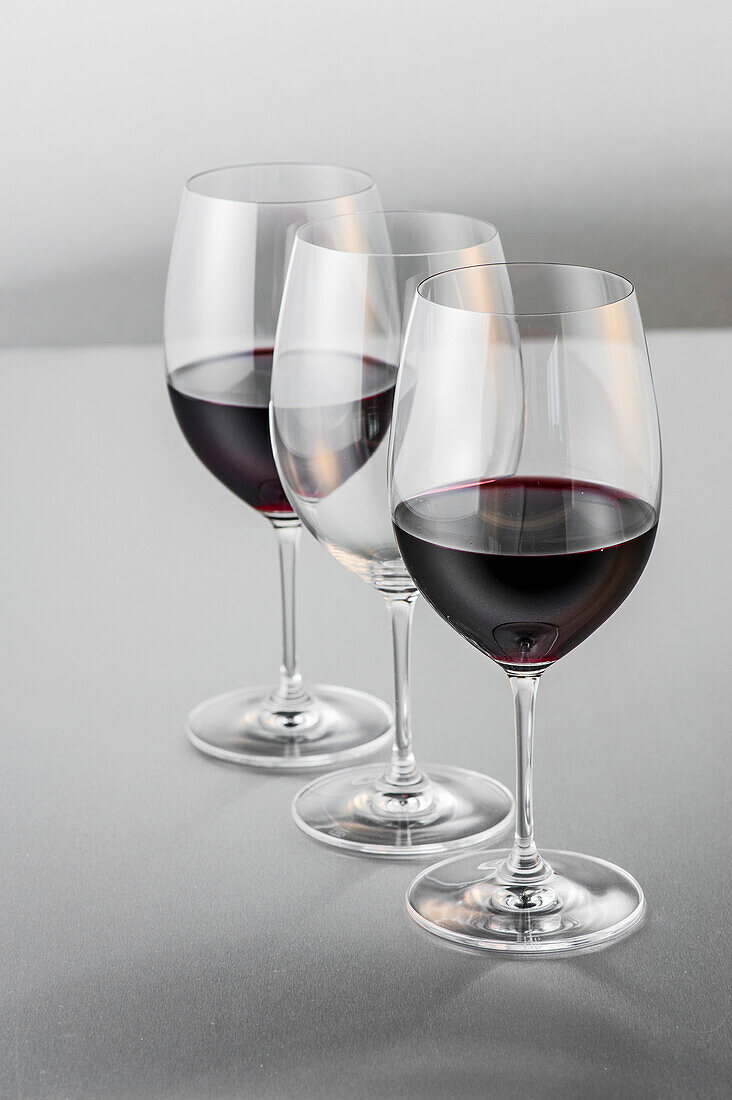 Two glasses of red wine and an empty glass, Hamburg, Northern Germany, Germany