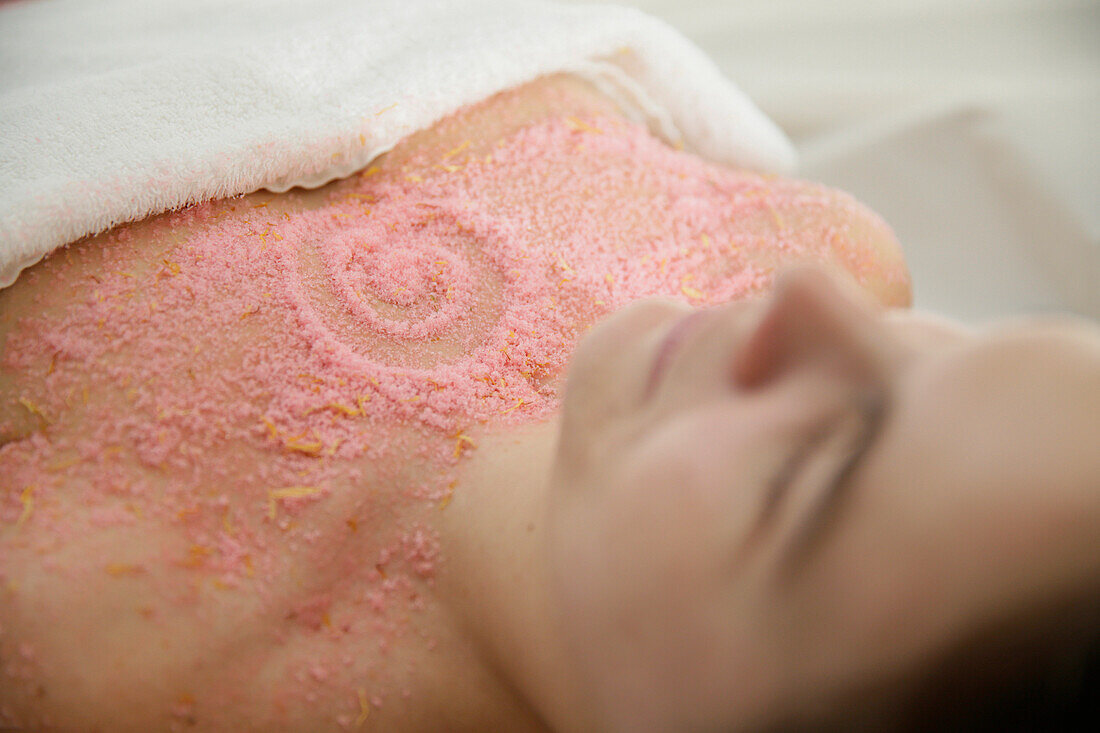 Woman with exfoliating salt scrub