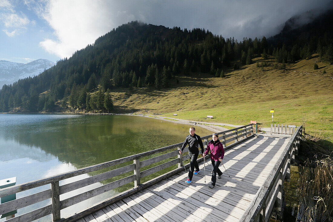 Two Nordic Walkers at lake Vilsalpsee, Tannheim, Tannheim Valley, Tyrol, Austria