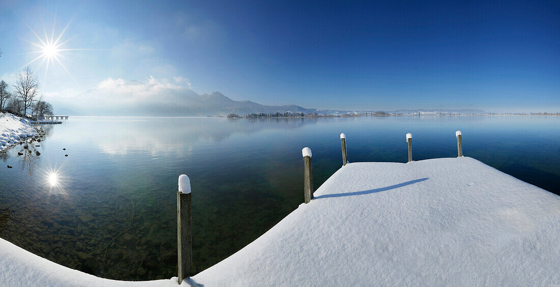 Snow-covered jetty at lake Kochel, Upper Bavaria, Germany