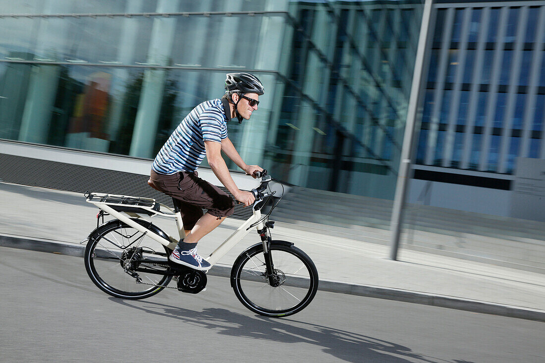 Man riding an e-bike, Munich, Bavaria, Germany