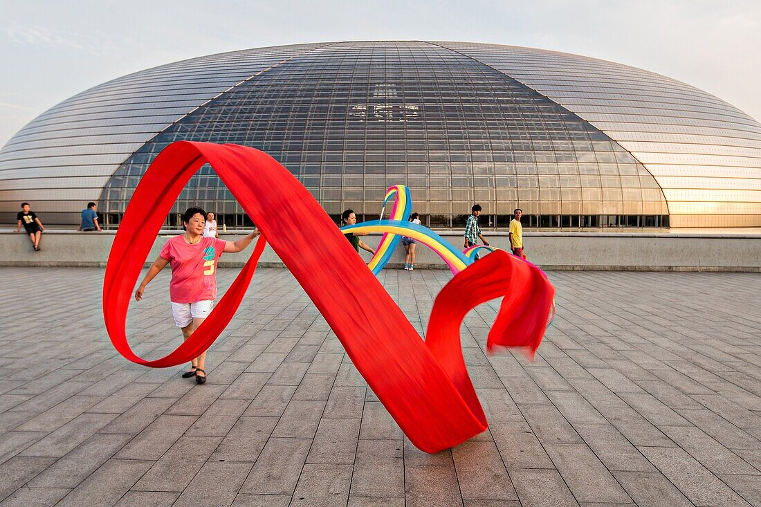Women practice ribbon dancing at the National Centre for Performing Arts park in Beijing, China
