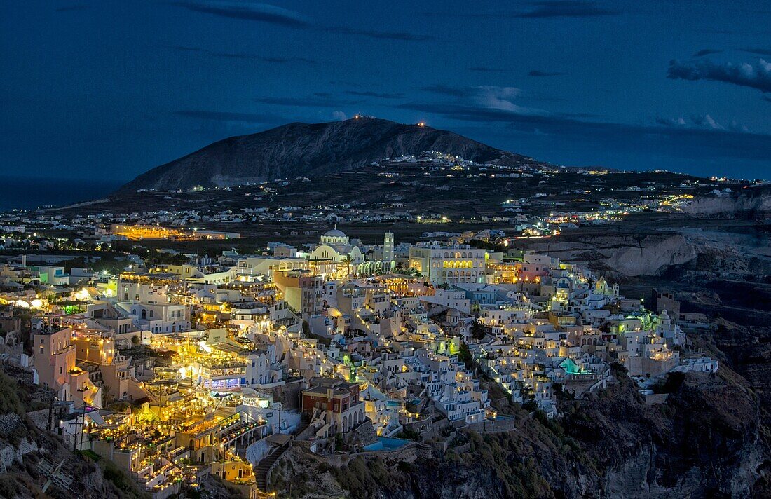 City of Fira Santorini Greece at night from mountains with sky and lights