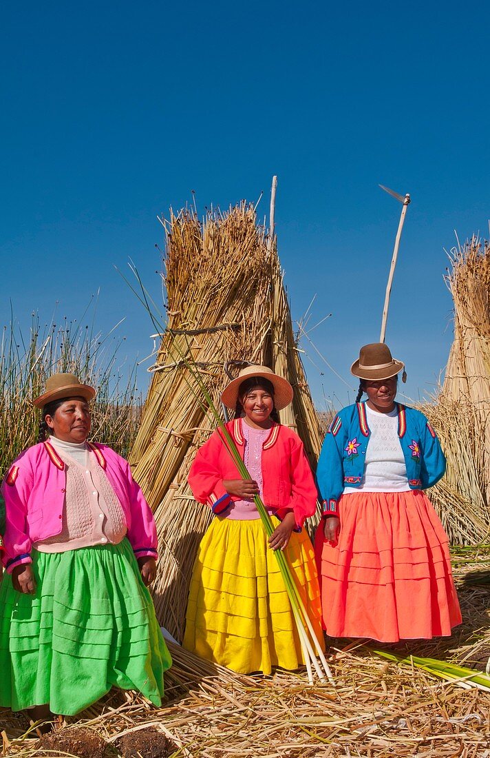 Lake Titicaca Peru with local traditional women of Uros Tribe history in colorful clothes near Puno