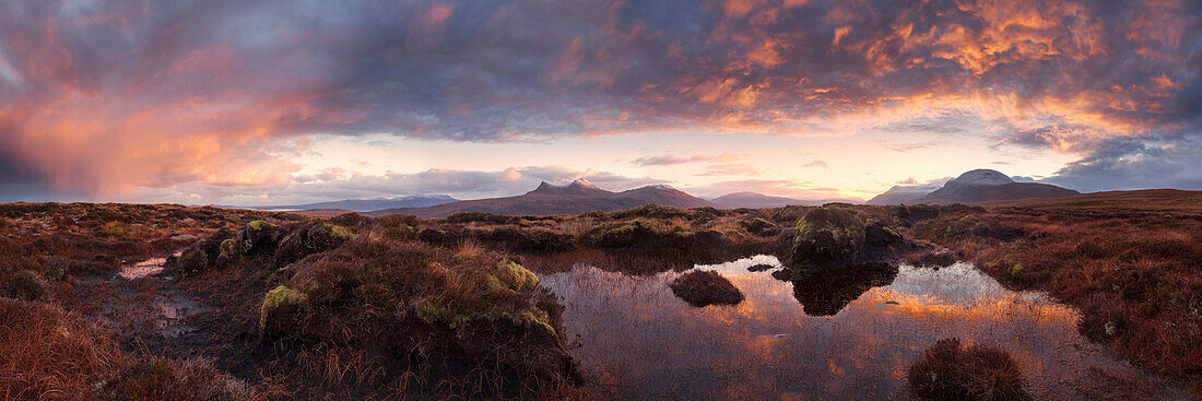 Vast panorama of the North West Highlands with a view to the summits of the An Teallach mountains during a spectacular sunrise, Torridon, Ullapool, Scotland, United Kingdom