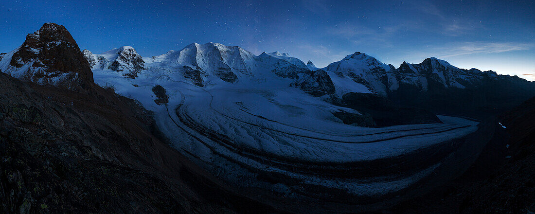 View above the imposing Pers Glacier in the blue light of the incipient night with first stars showing up over the summits of Piz Trovat (3146 m), Piz Cambrena (3602 m), Piz Palu (3901 m), Piz Zupo (3996 m) and Piz Bernina (4048 m) (from left), Engadin, S