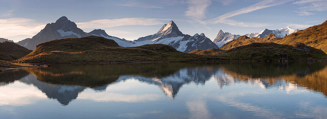 Morning sun above the mountain lake Bachalpsee with the peaks of Wetterhorn, Schreckhorn, Finsteraarhorn and Gross Fiescherhorn in the background, Grindelwald, Bernese Oberland, Switzerland