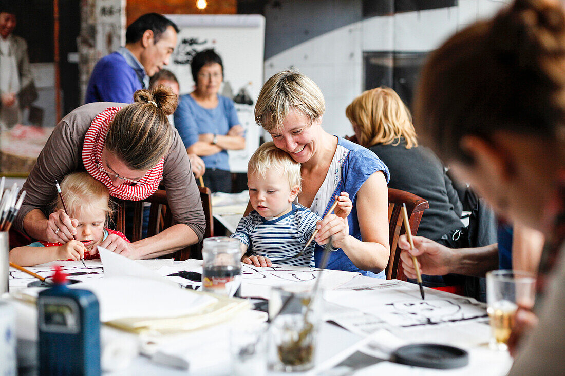 Children attending at a workhop chinese ink painting, Leipzig, Saxony, Germany