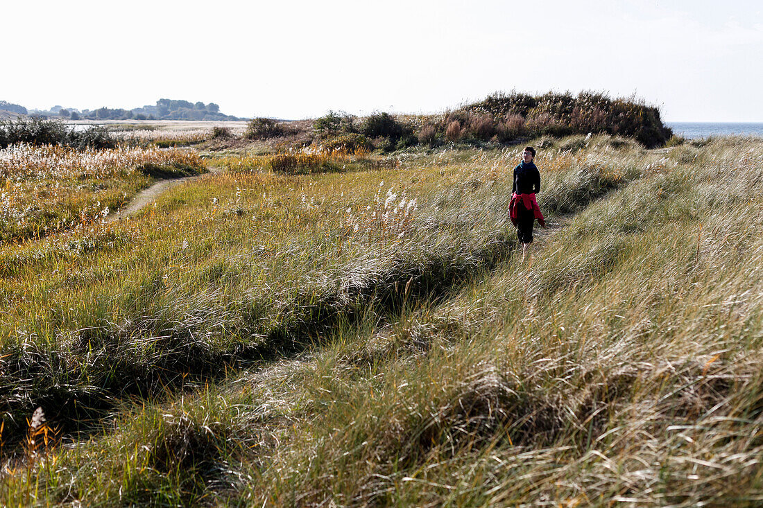 Woman at Baltic Sea beach near Kagsdorf, Bastorf, Mecklenburg-Western Pomerania, Germany