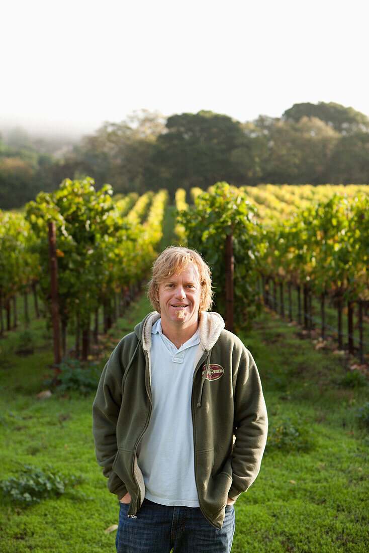 USA, California, Gundlach Bundschu Winery, sixth generation vineyard owner and manager Jeff Bundschu in the vines