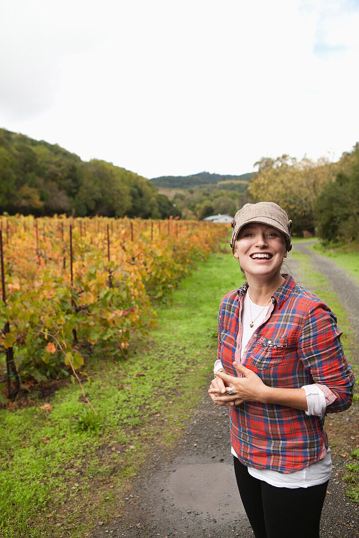 USA, California, Sonoma, Kit Paquin smiles in the vineyard at Ravenswood winery and vineyard