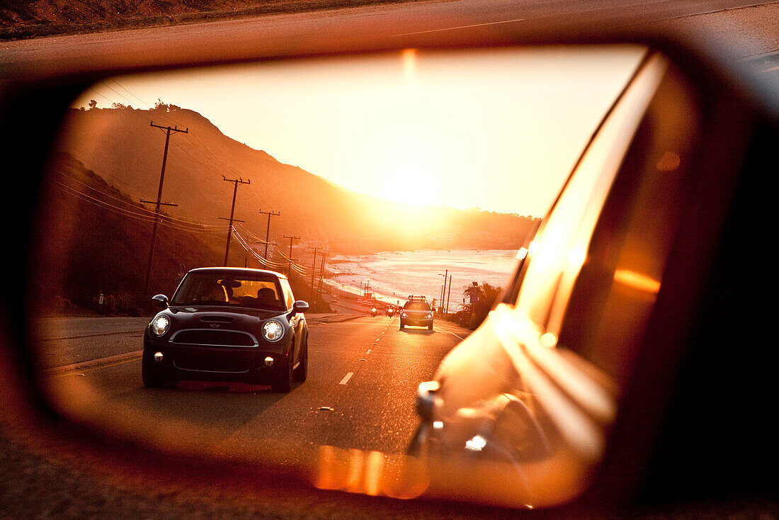 USA, California, Malibu, view of the Pacific Coast Highway at sunset as seen in the rear view mirror