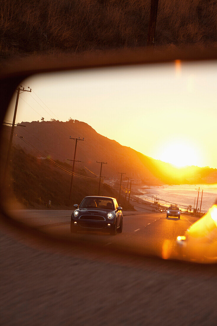 USA, California, Malibu, view of the Pacific Coast Highway at sunset as seen in the rear view mirror