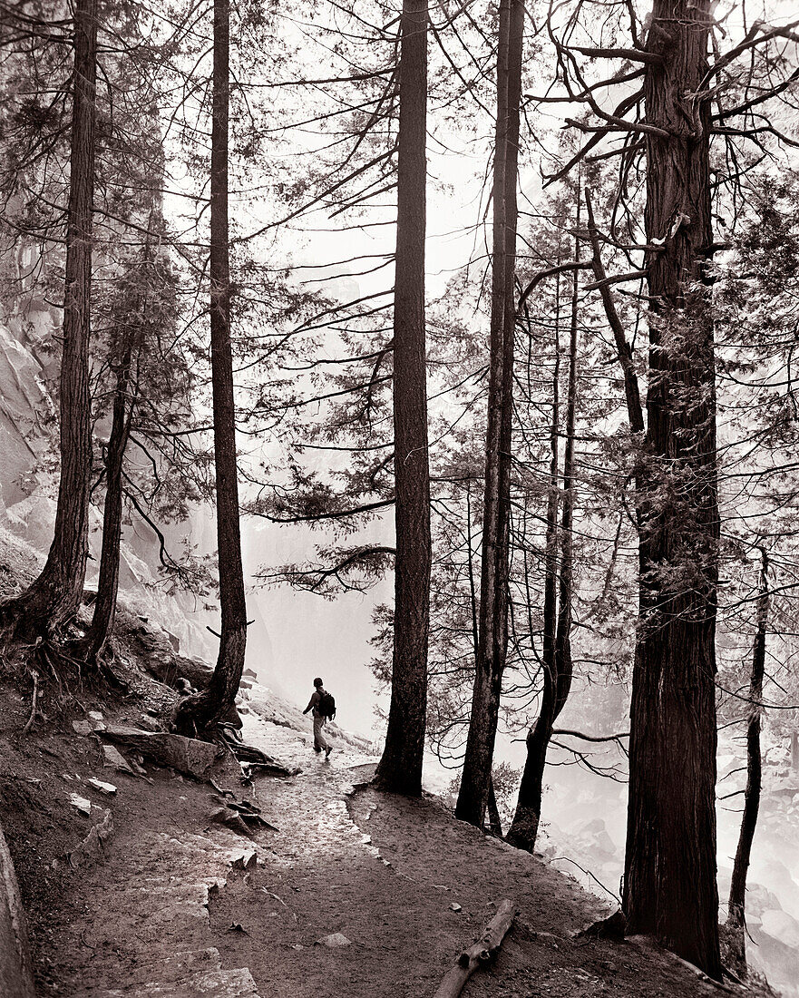 USA, California, Yosemite National Park, a woman hikes the trail down from Vernal Falls (B&W)