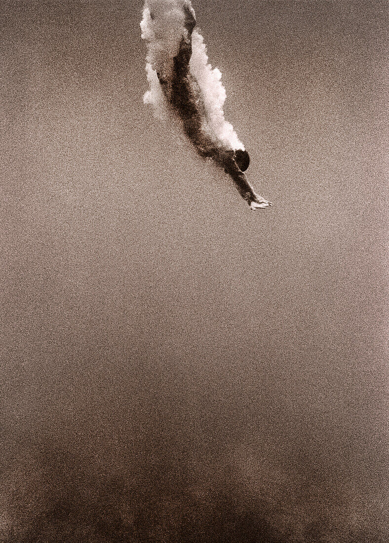 CAYMAN ISLANDS, Cayman Brac, a man dives into the ocean (B&W)