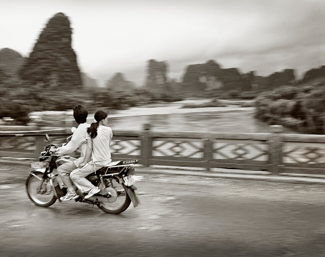 CHINA, Guilin, couple traveling on motorcycle in rural Guilin (B&W)
