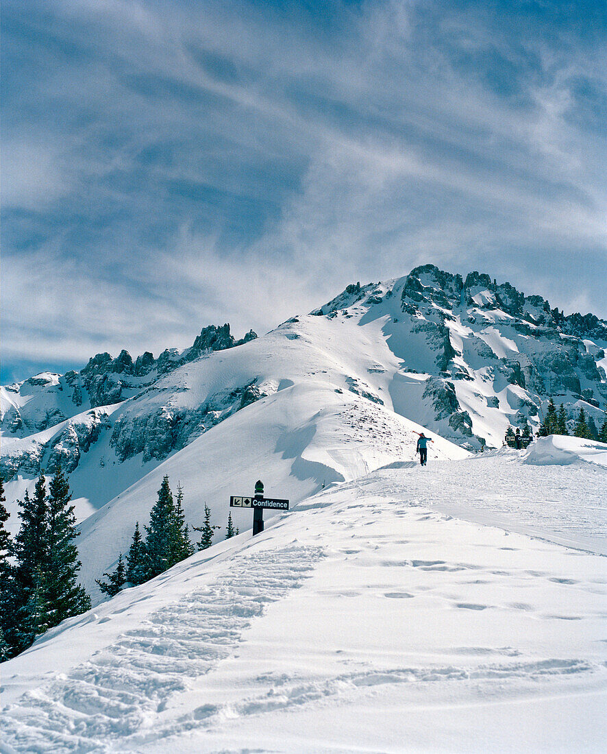 USA, Colorado, Skier hiking up the mountain to ski expert terrain, Telluride Ski Resort
