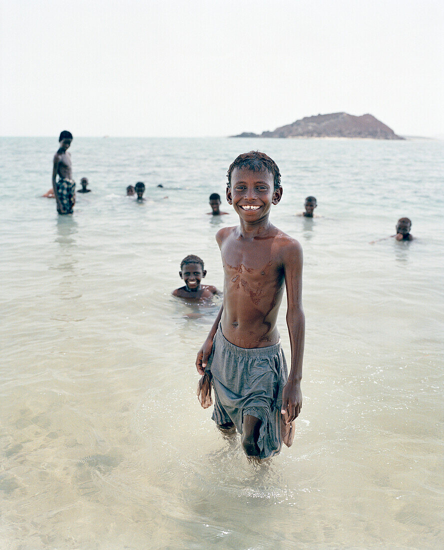 ERITREA, Beraasole, kids swim in the Red Sea in the fishing village of Beraasole