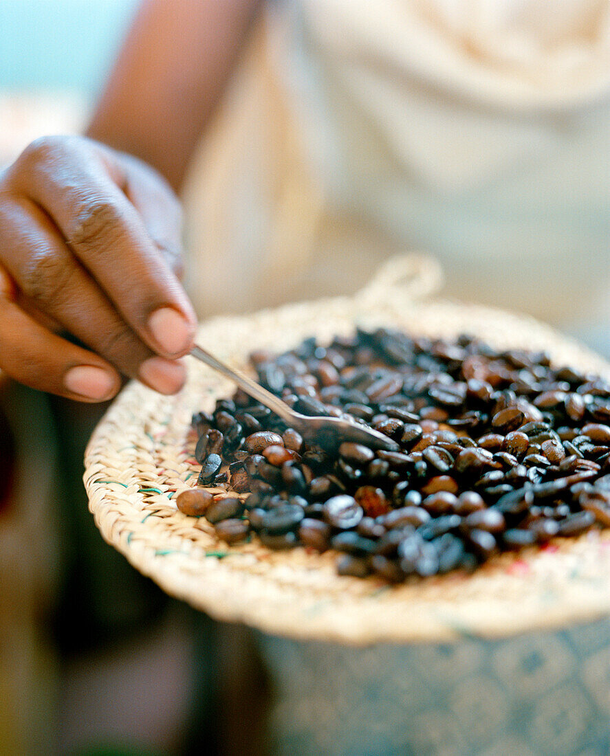 ERITREA, Tio, a woman named Sawit prepares coffee on the side of the road in Tio