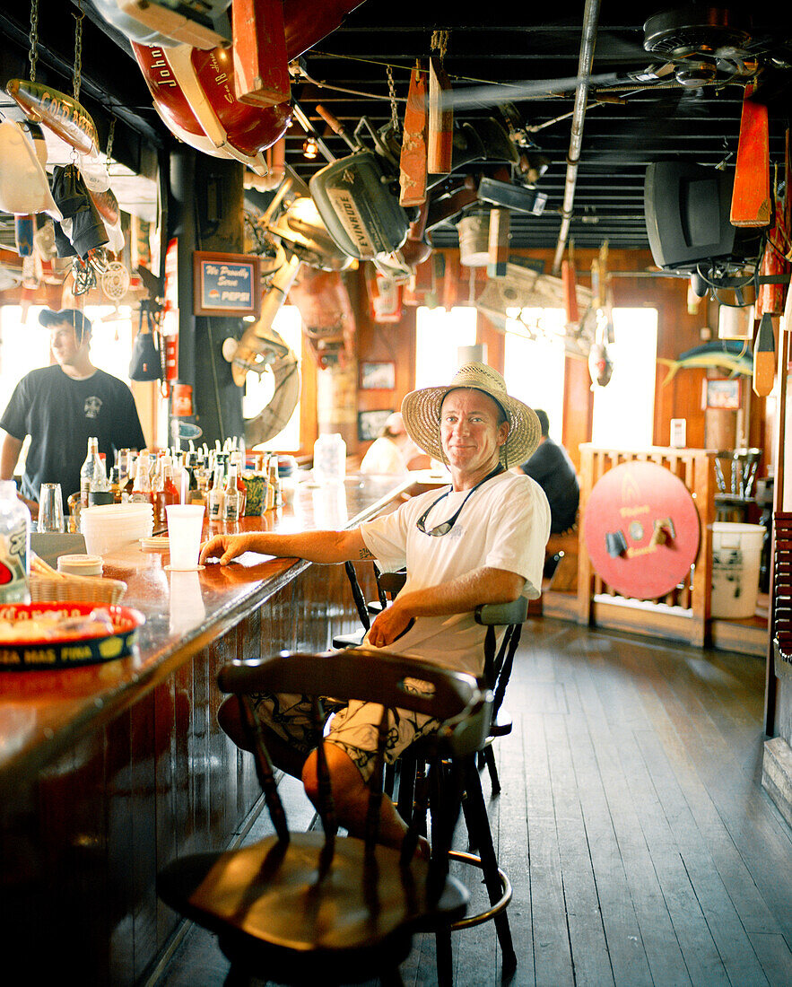 USA, Florida, man sitting at bar, Aj's Seafood Restaurant, Destin
