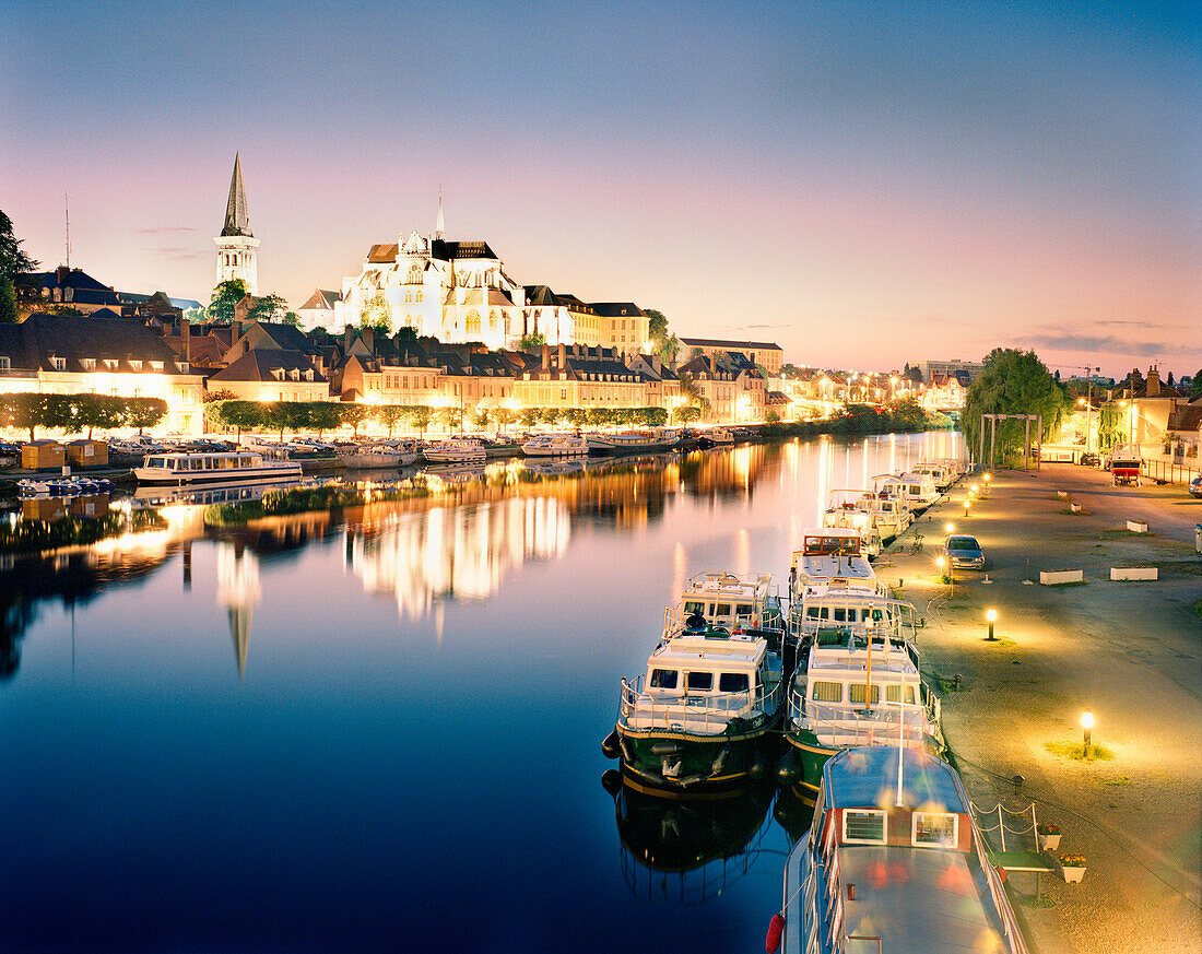 FRANCE, Burgundy, Abaye Saint Germain reflecting on the Yonne river at night, Auxerre