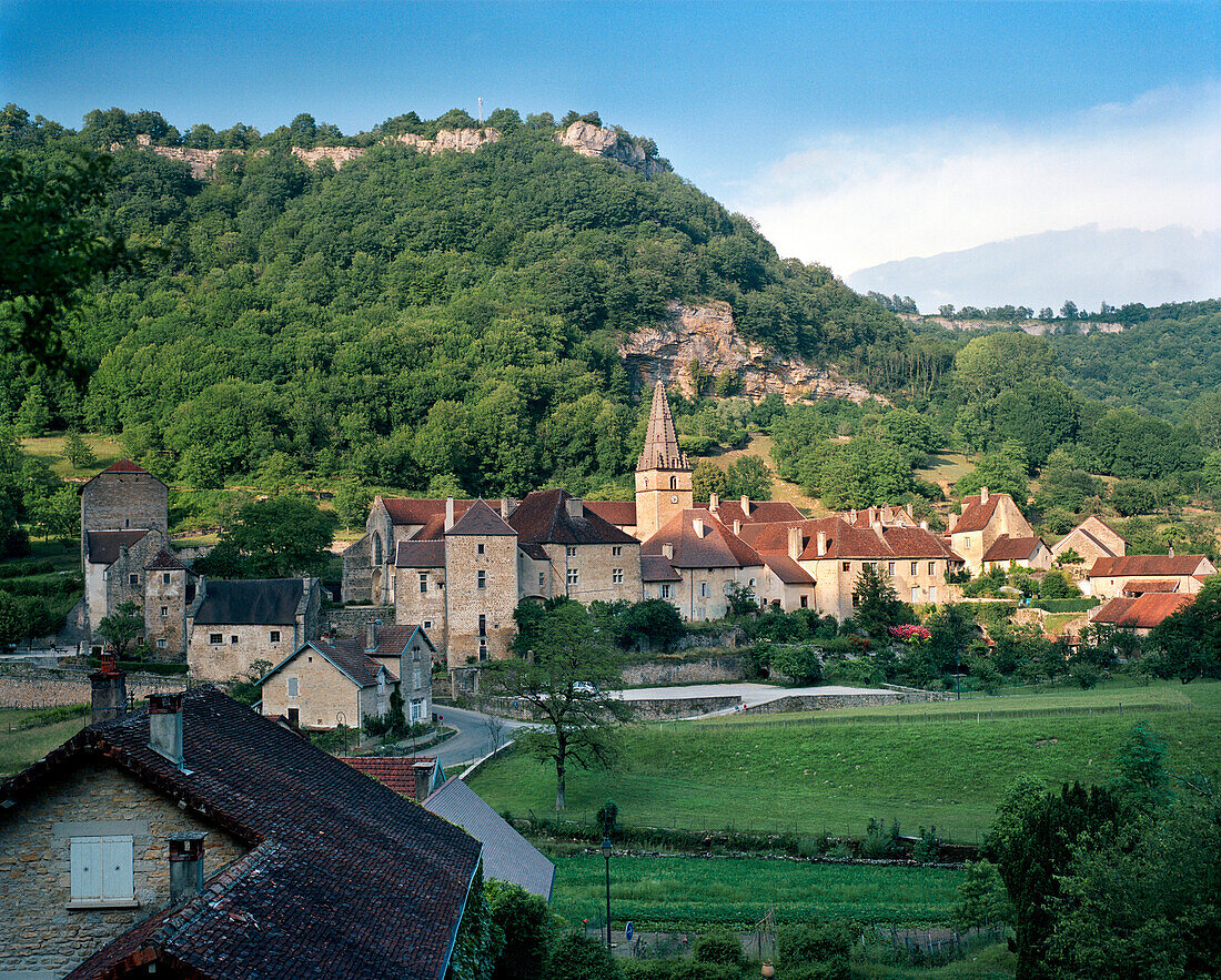 FRANCE, Baume les Messieurs, the village and 8th Century Abbey nestled at the base of steep rock faces, Jura Wine Region