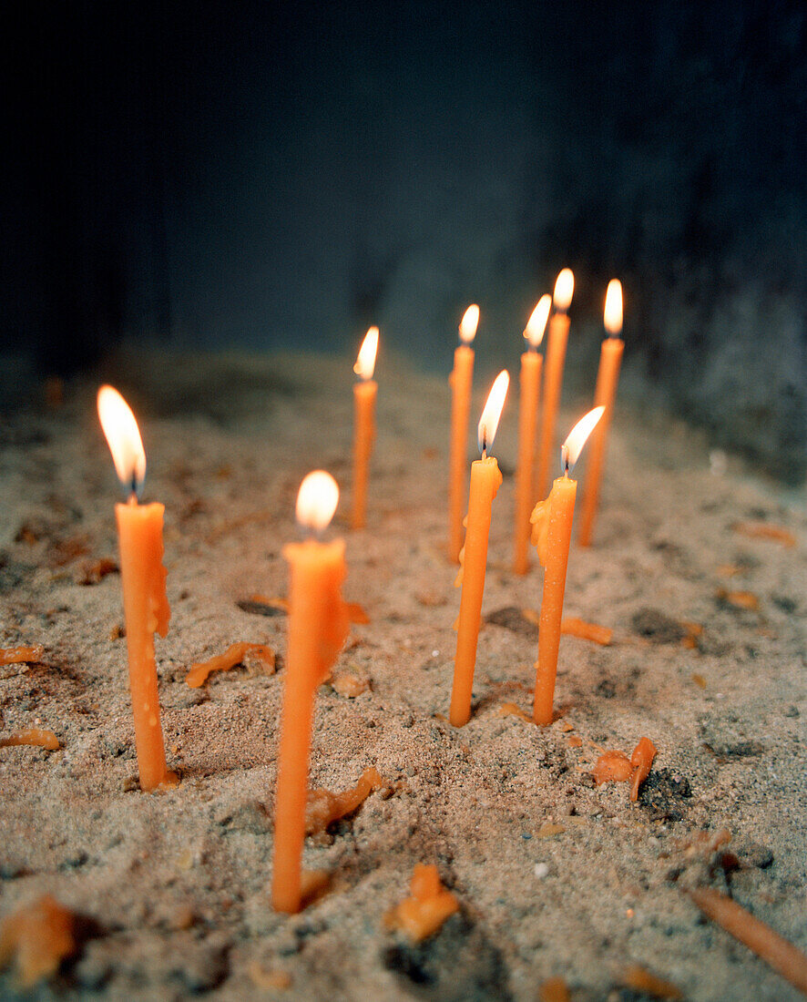 GREECE, Chora, Dodecanese Island, candles lit inside St. John’s Cathedral at the top of the island in the village of Chora