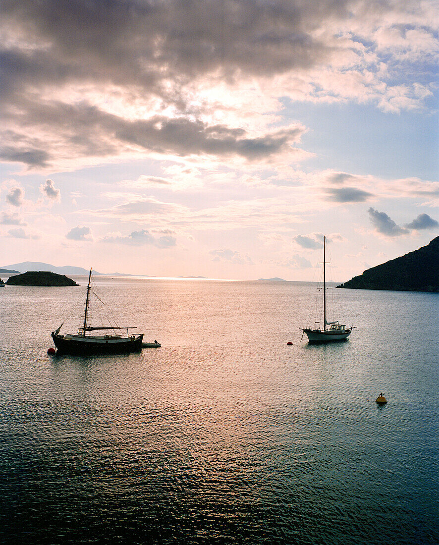 GREECE, Patmos, Grikos, Dodecanese Island, boats anchored in Grikos Bay at sundown, the Agean Sea