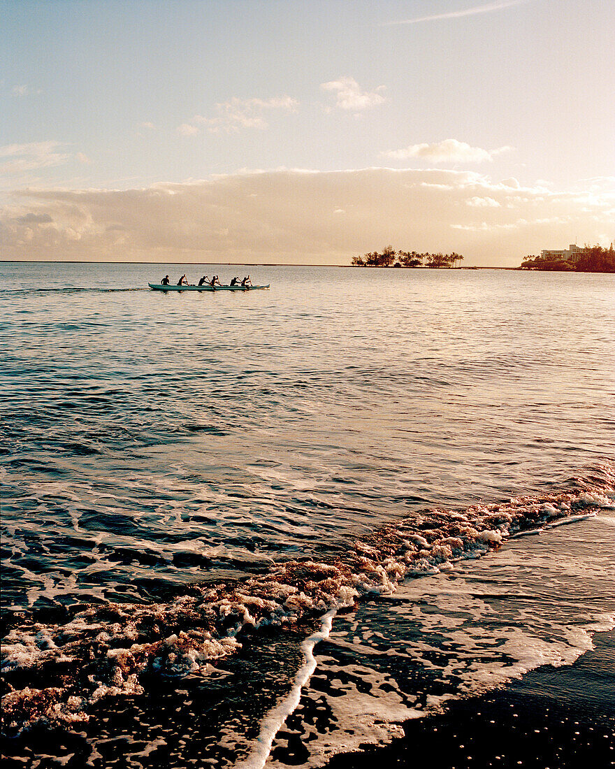 USA, Hawaii, Hilo, a team paddling an outrigger canoe in the Pacific Ocean
