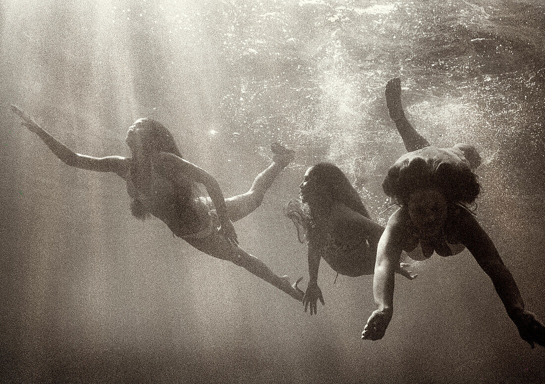 USA, Hawaii, women swimming in sea, Kealakekua Bay, The Big Island (B&W)