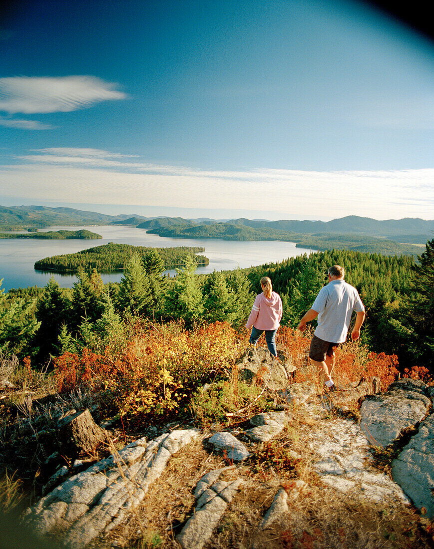 USA, Idaho, man and woman hiking on a mountain above Priest Lake