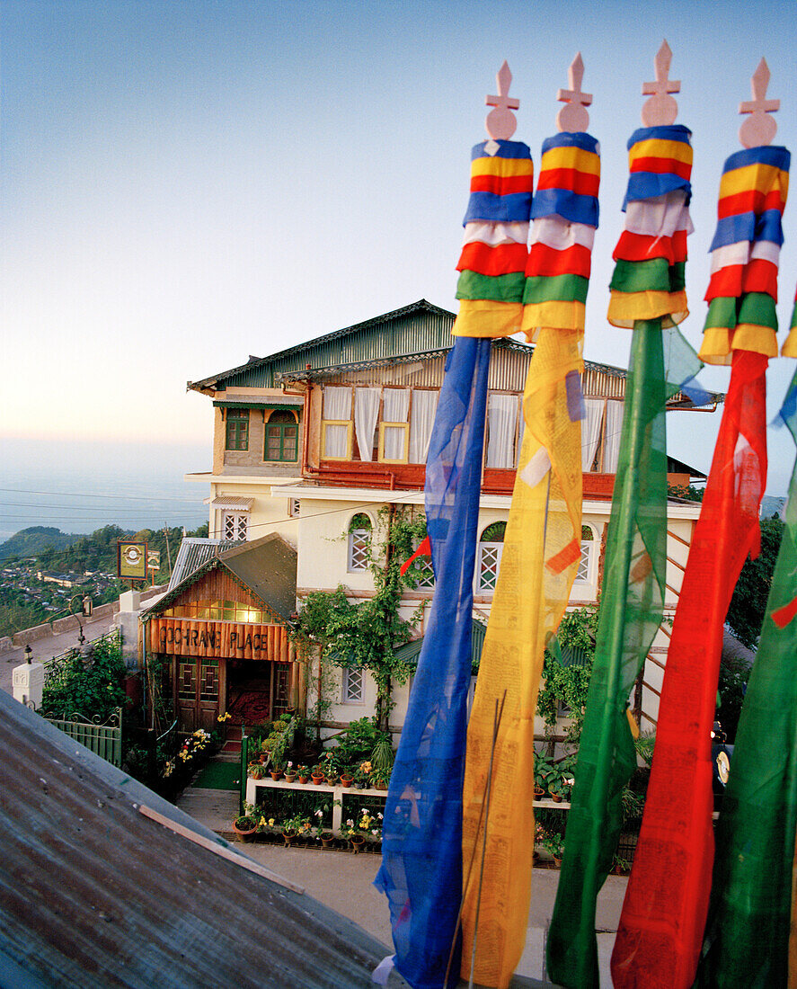 INDIA, West Bengal, colorful flags in front of hotel, Cochrane Palace, Kurseong