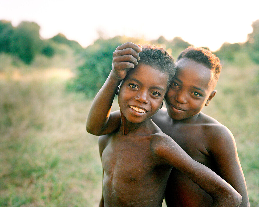 MADAGASCAR, two shirtless Mahafaly boys smiling, portrait, Mahazoarivo Village