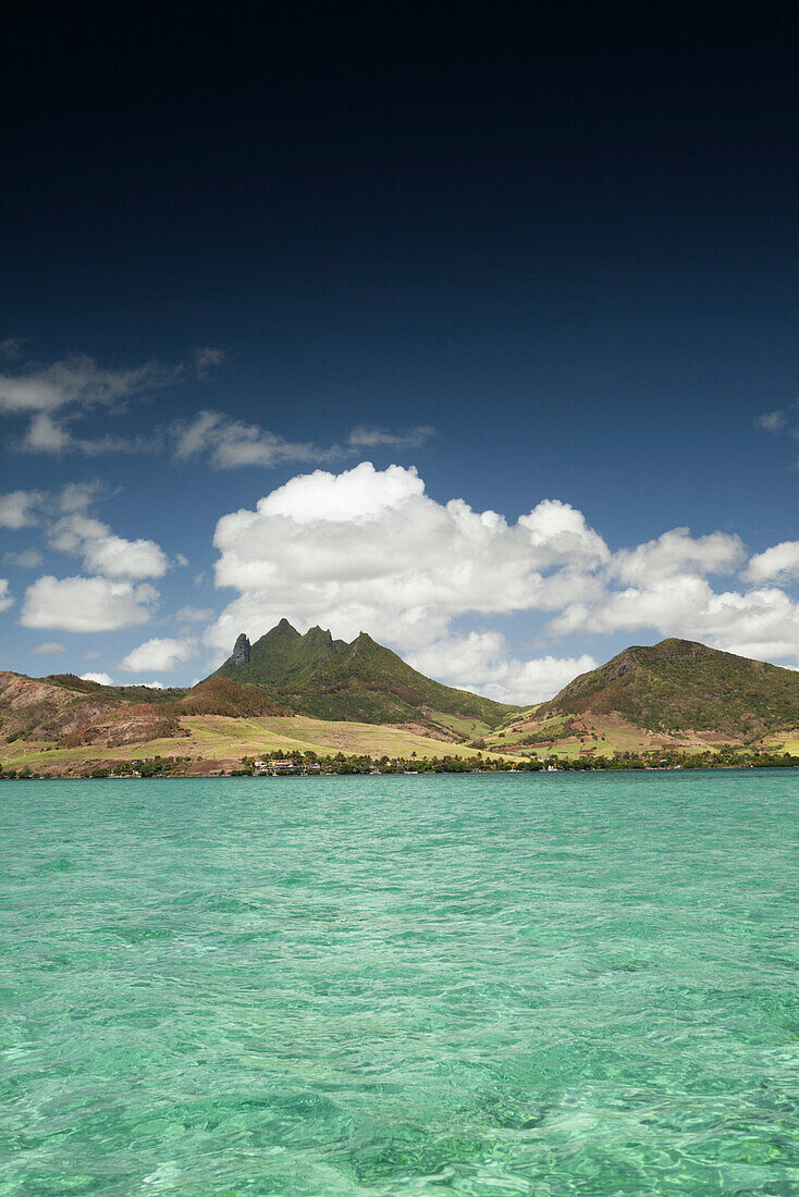 MAURITIUS, Trou D'eau Deuce, sailing in the Indian Ocean off the East coast of Mauritius with the 4 Sisters Mountains in the background