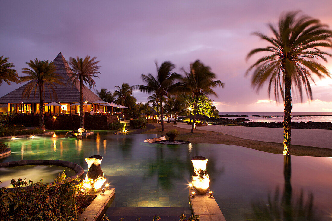 MAURITIUS, Chemin Grenier, South Coast, the pool and Pebbles restaurant during sunset at Hotel Shanti Maurice, located on the Indian Ocean