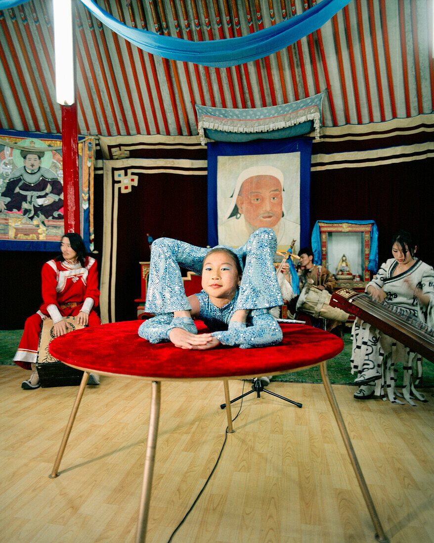 MONGOLIA, Ulaanbaatar, a young acrobat performs at the Abtai-Sain Khan Palace