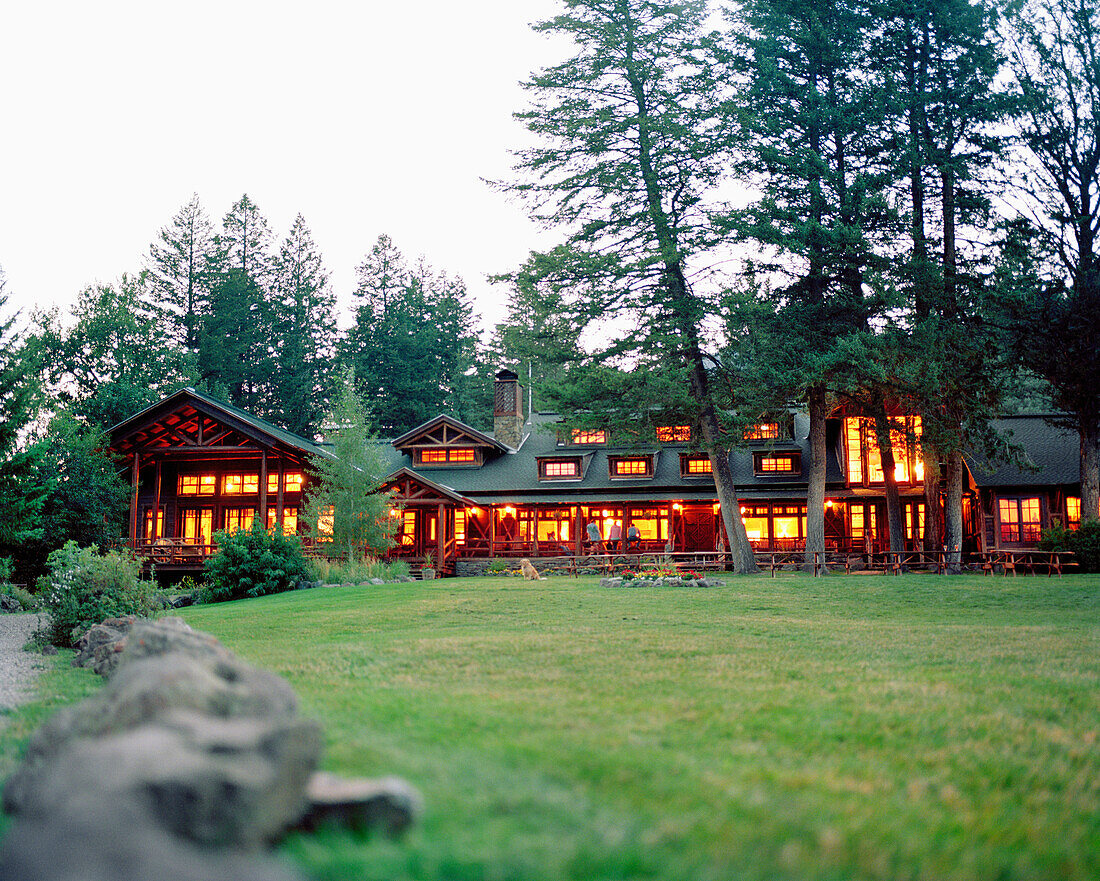 USA, Montana, exterior of illuminated lodge, Mountain Sky Guest Ranch