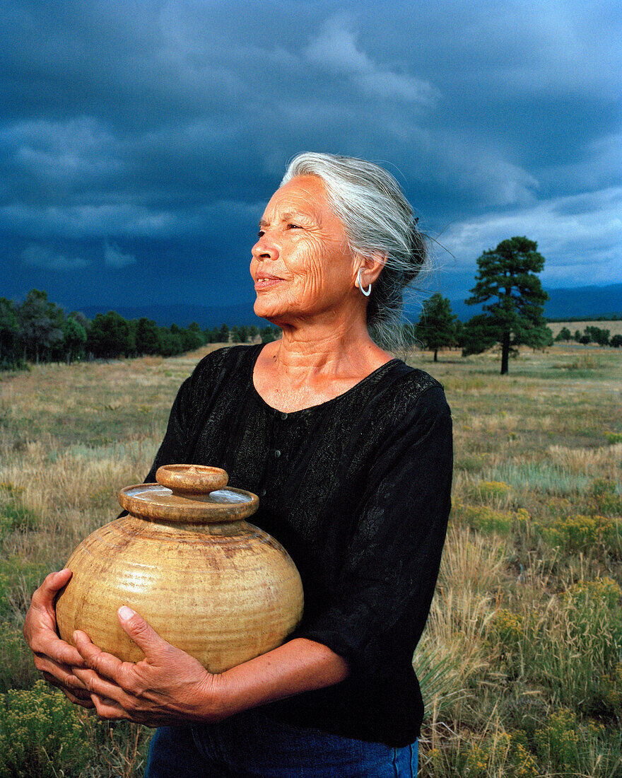 USA, New Mexico, beautiful Native American woman holding a pot, Valley of the Wild Roses