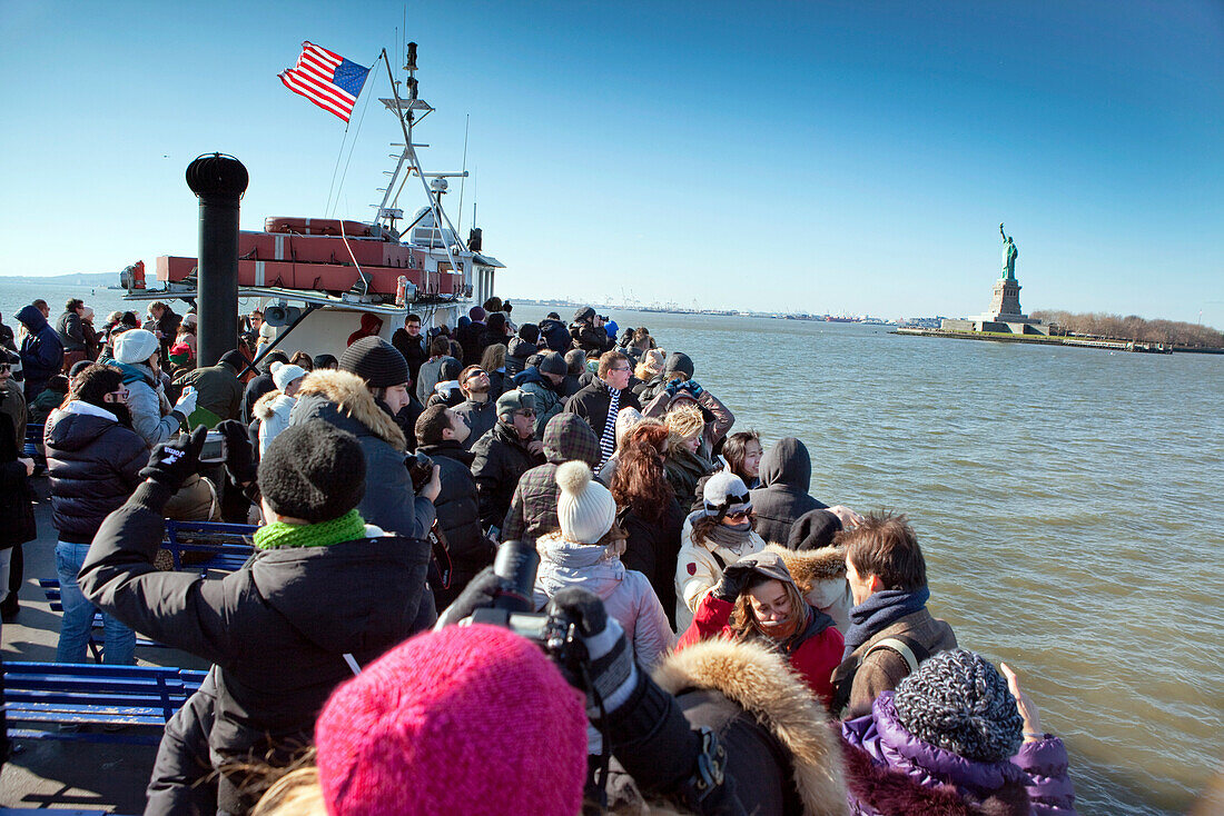 USA, New York, tourists on a boat tour to visit the Statue of Liberty National Monument and Ellis Island