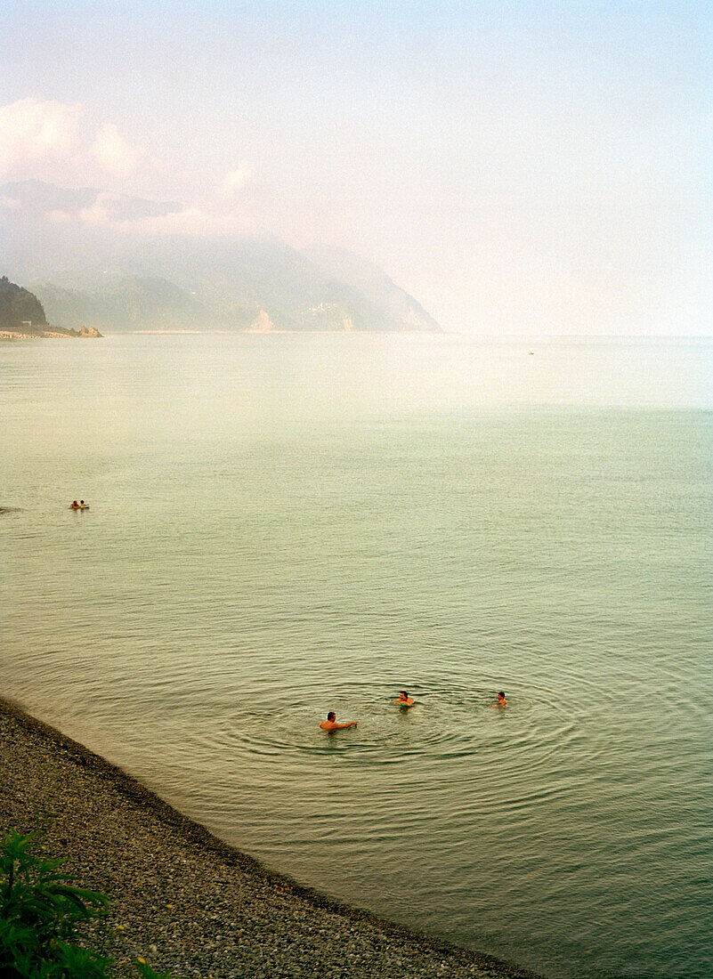 REPUBLIC OF GEORGIA, Batumi, people swimming in the Black Sea, Turkey in distance
