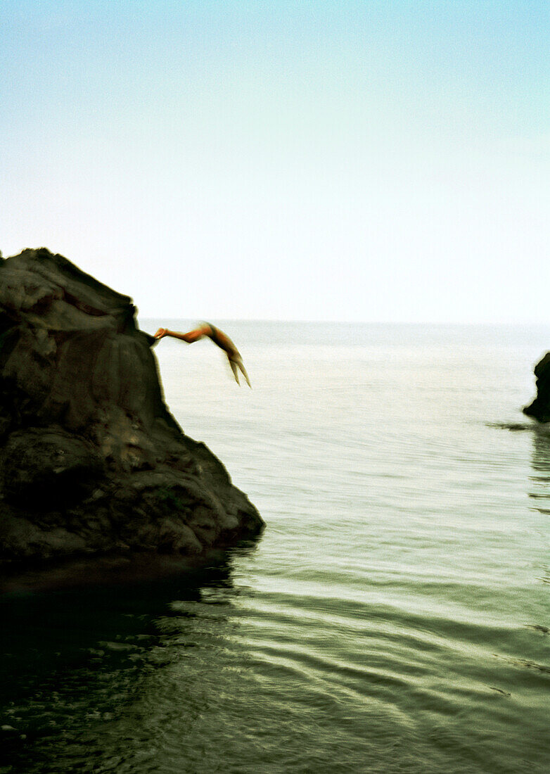 REPUBLIC OF GEORGIA, person diving from the rocks into the Black Sea