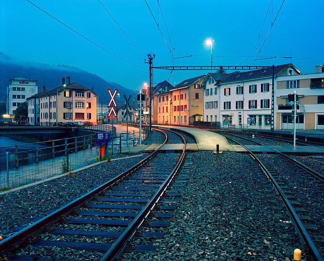 SWITZERLAND, Couvet, the train station at dusk, Jura Region