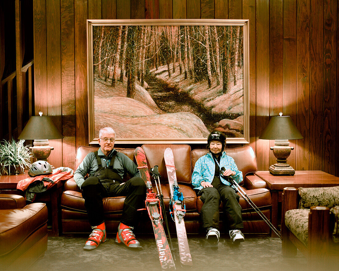 USA, Utah, senior man and woman sitting in ski gear at Alta's Rustler Lodge