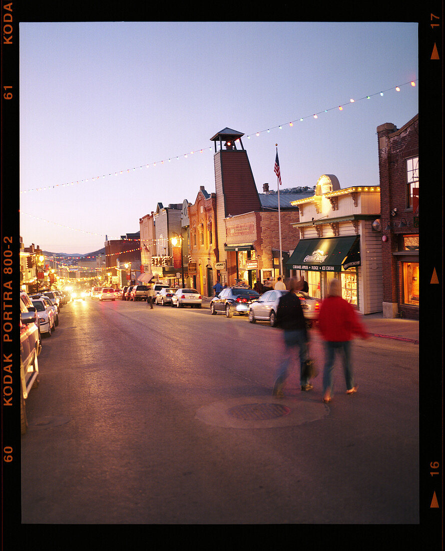USA, Utah, Park City, a couple crossing the street in downtown Park City at night