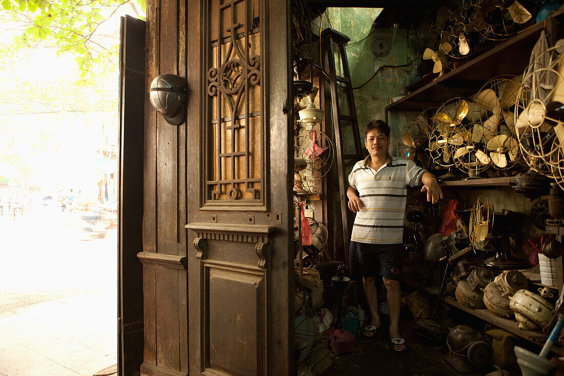 VIETNAM, Hanoi, the owner of an old fan shop in his shop in the old quarter
