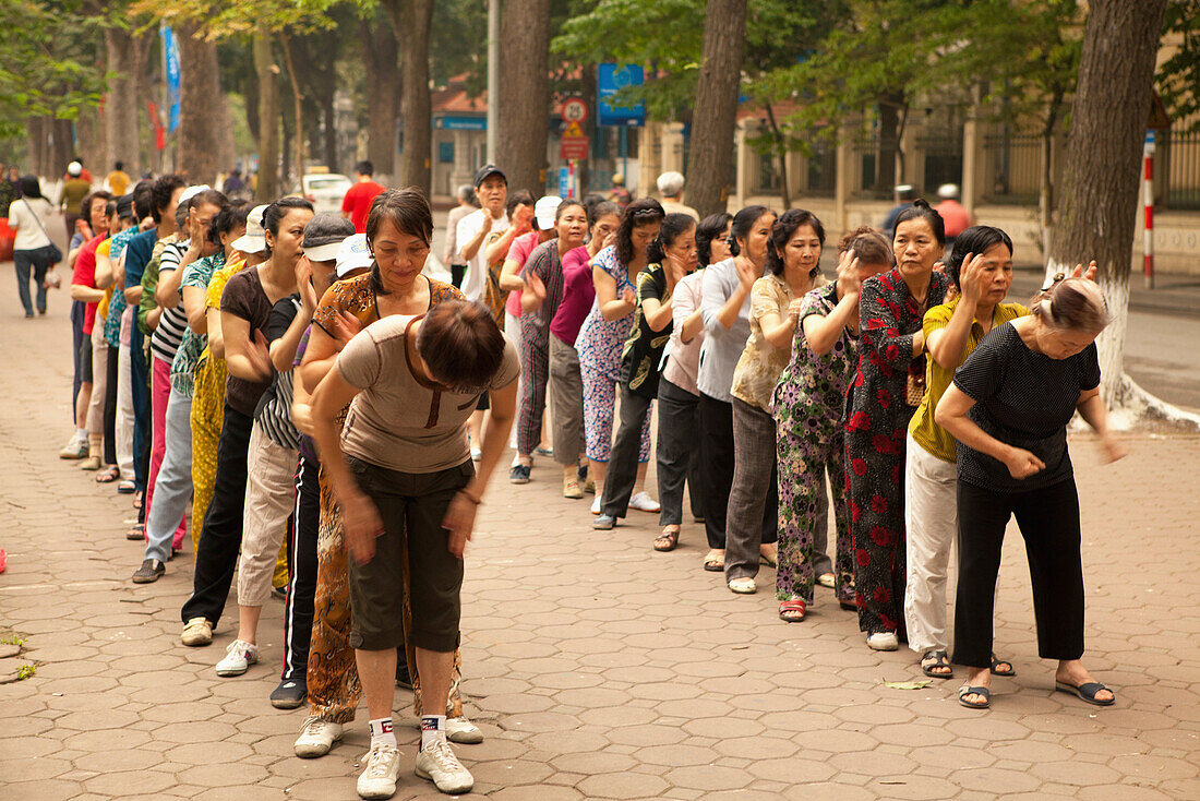 VIETNAM, Hanoi, women perform Tai Chi and stretch early in the morning, Hoan Kiem Lake