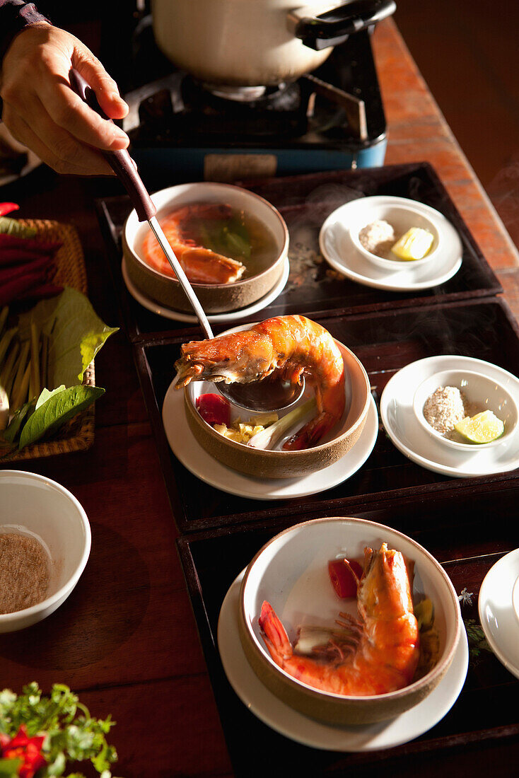 VIETNAM, Hue, Ms. Boi Tran serves a dish she calls Shrimp with five tastes at her home in Hue