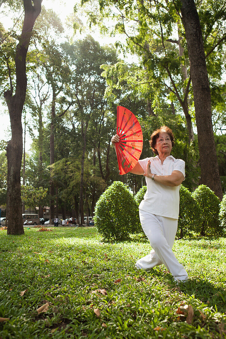 VIETNAM, Saigon, Ho Chi Minh City, women exercise and perform perfect movements with fans in the early morning