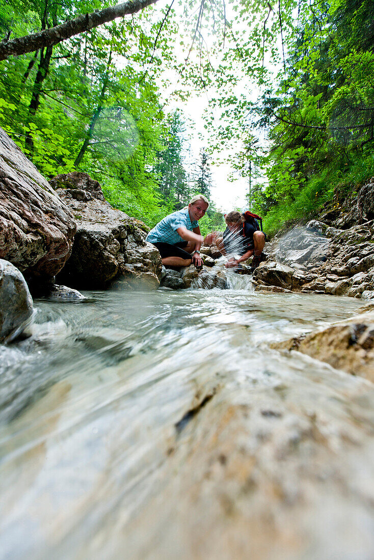 Hikers at a stream, Hochschwab mountain area, Aflenz, Styria, Austria